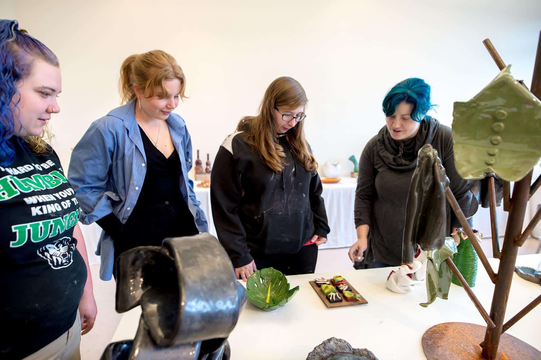 art students reviewing a piece by another student