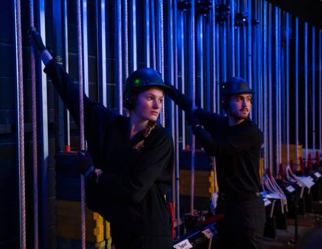 Two stage hands working backstage