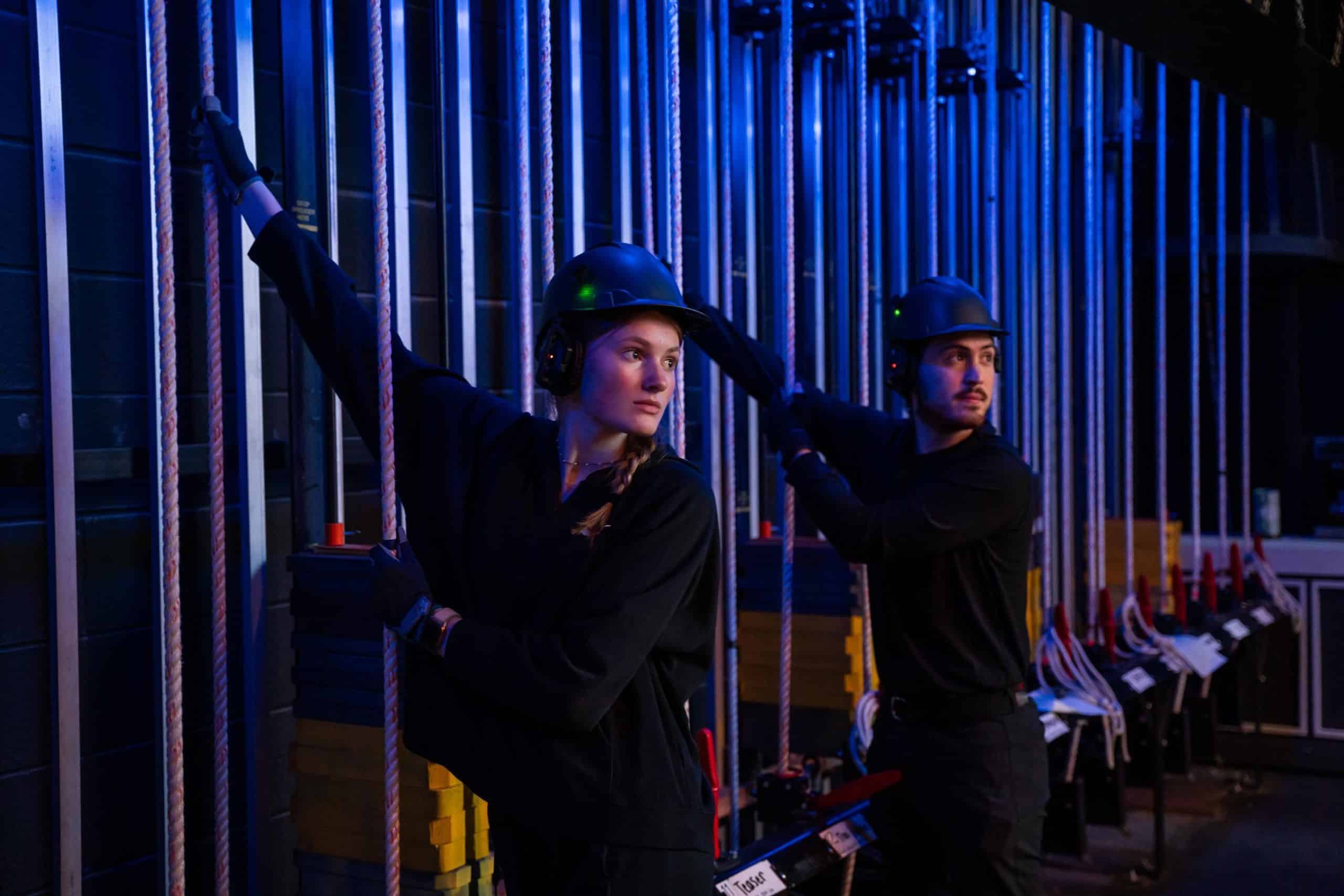 Two stage hands working backstage