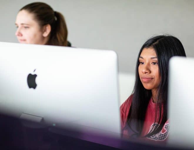Two female students working on Mac computers