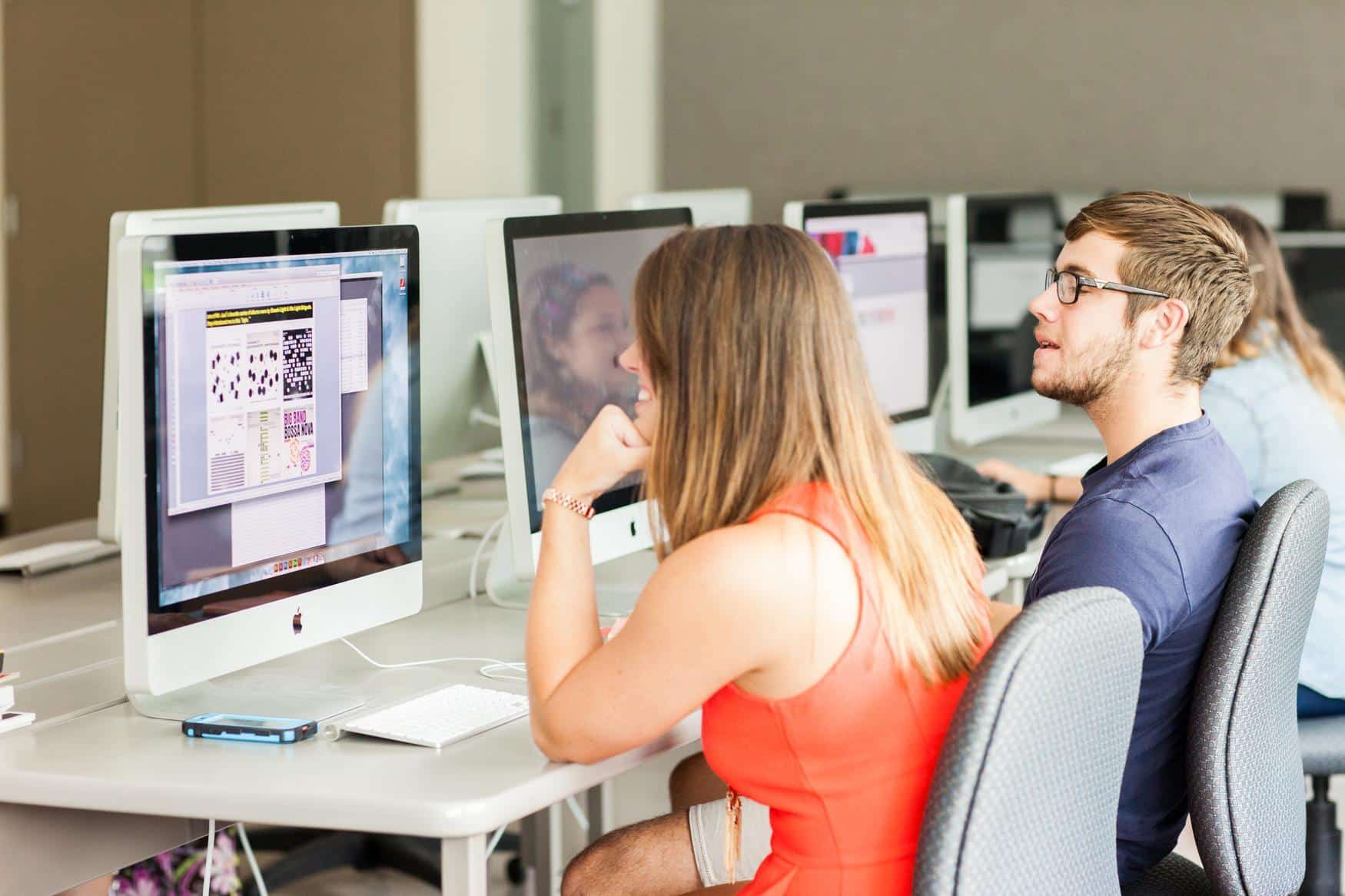 Students in a computer lab working on Mac computers.