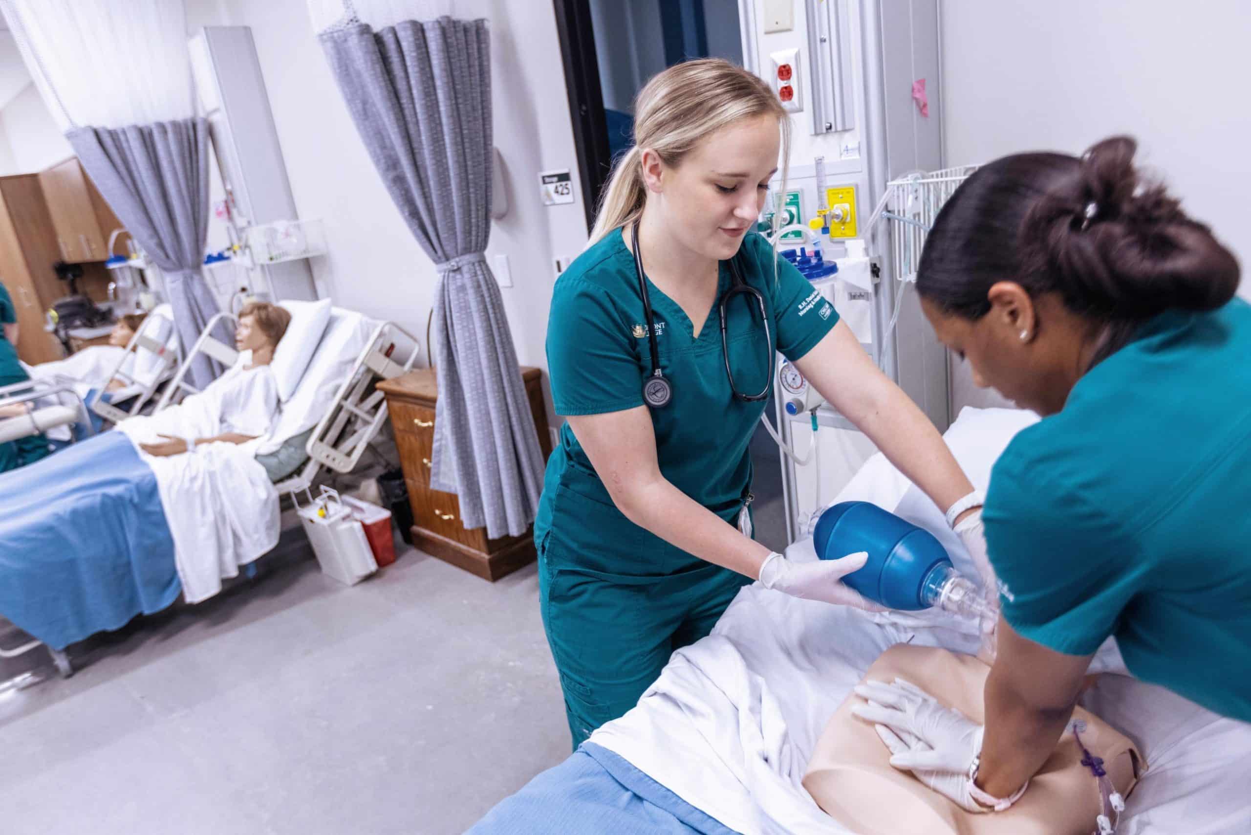 Two students working with a CPR dummy
