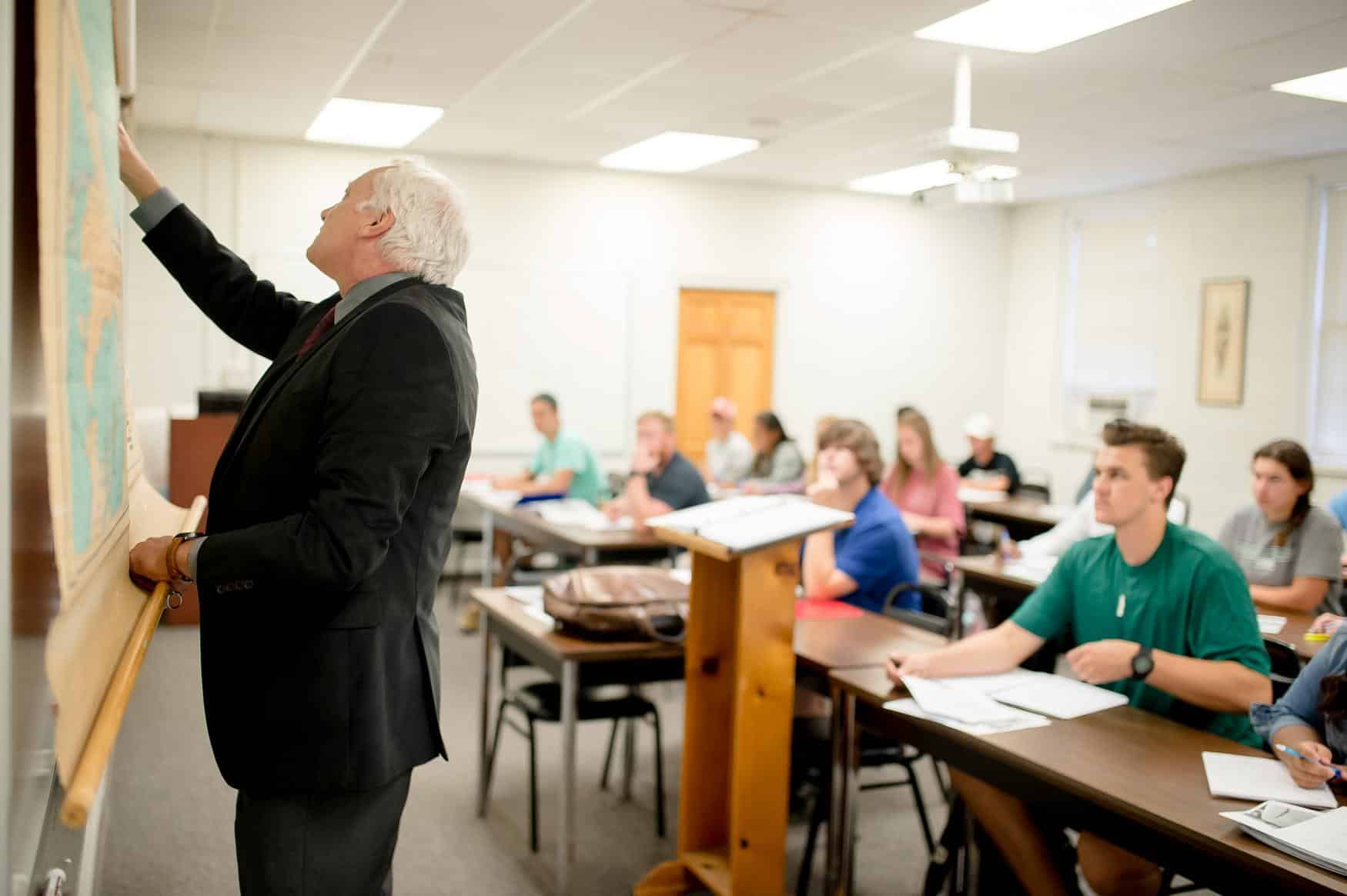 Professor Pleyser teaching students in history class.