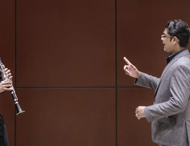 Student playing clarinet with professor