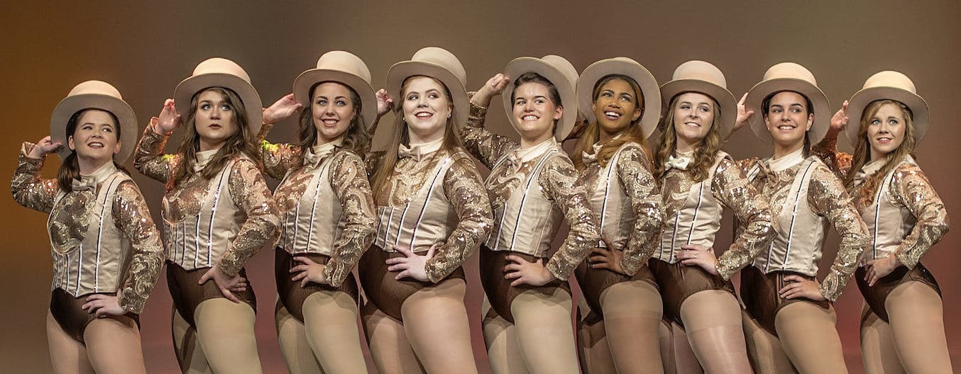 Actresses in a line during a musical theatre production