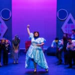 Performers onstage wearing animal masks.