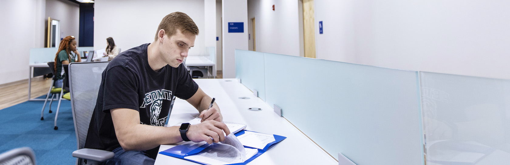 Student at table with folder