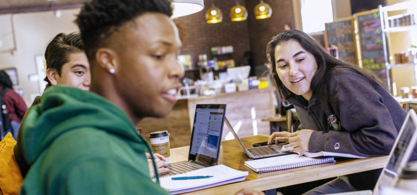 Students looking at laptop