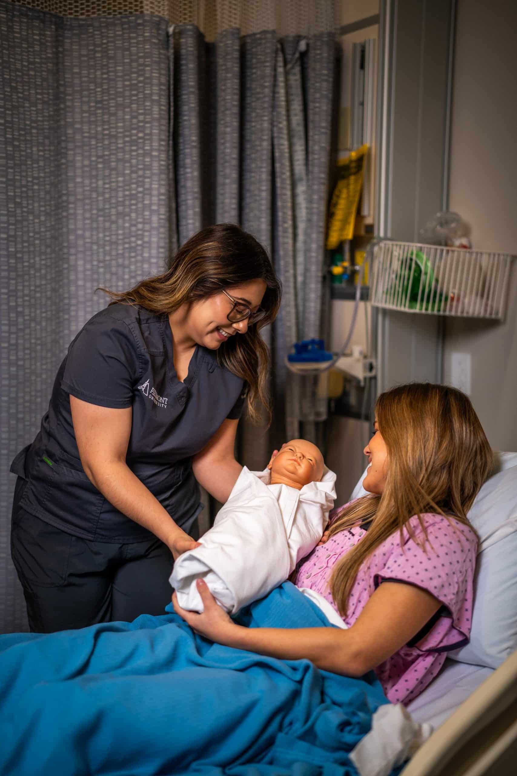 Nursing students practice with a infant medical dummy
