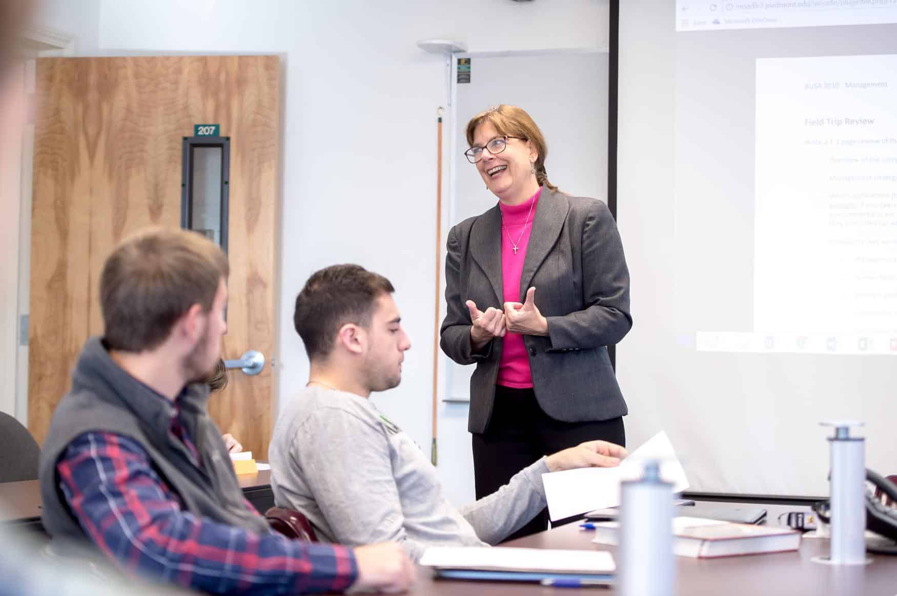 Professor smiling and leading a lecture on accounting