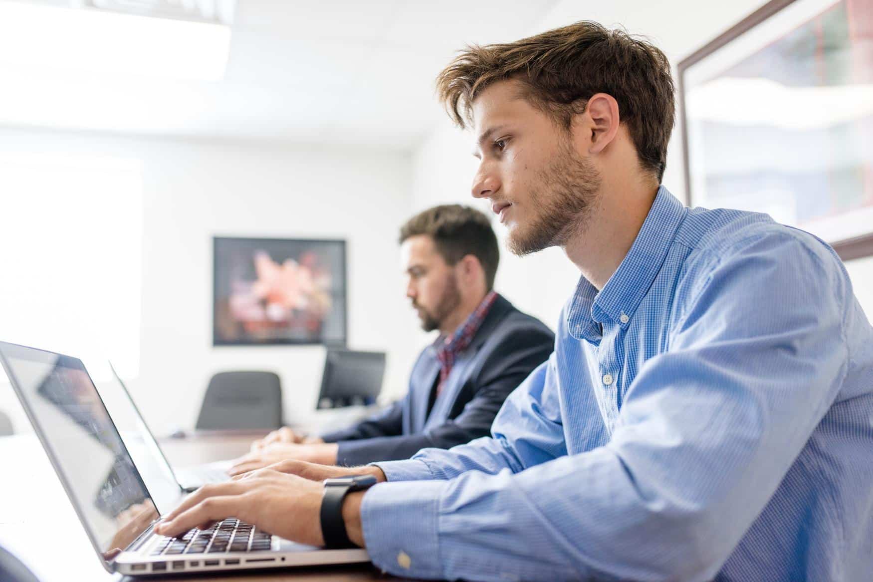 Two students working on laptops
