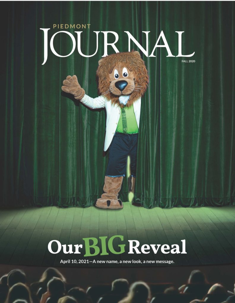 Cover of the Journal magazine with mascot on stage