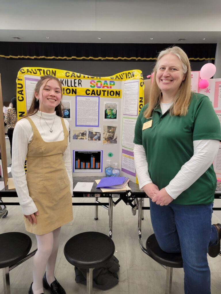 Student and professor at a science fair