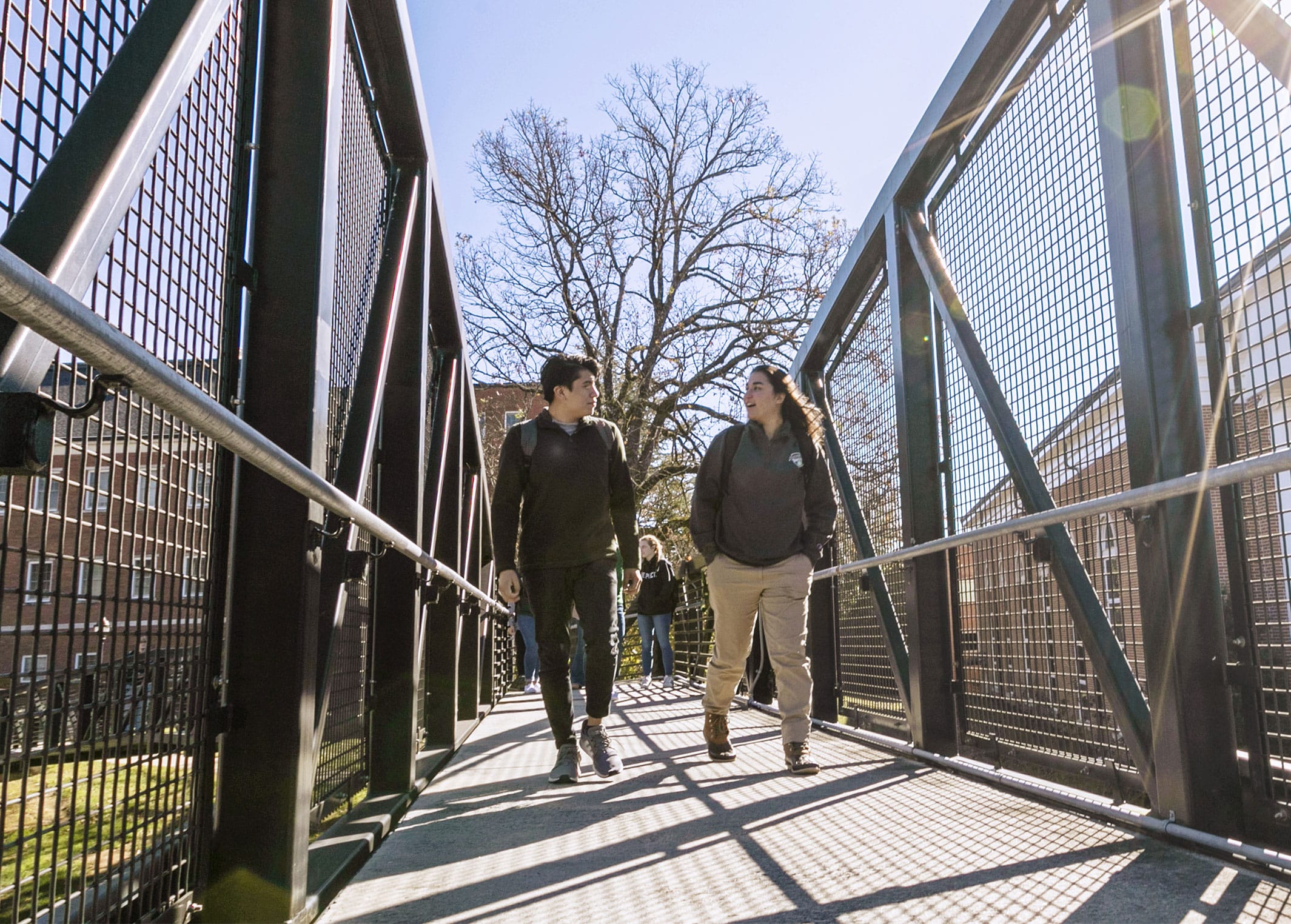 Two students walking across a bridge on the Piedmont campus