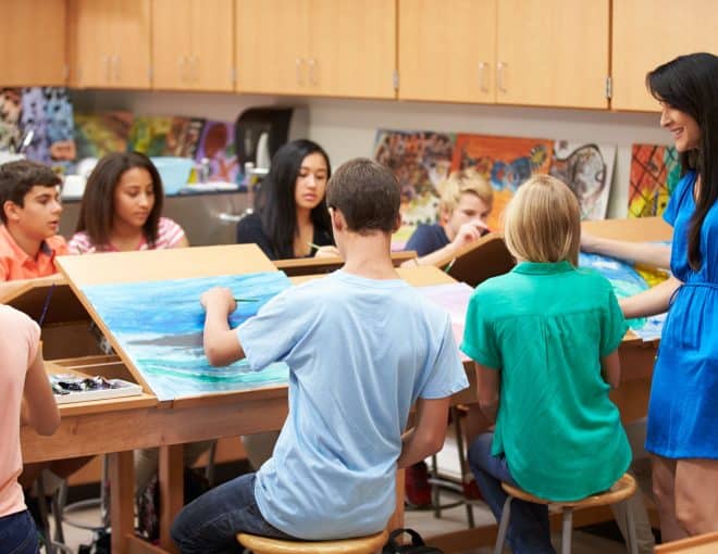 teacher in middle school art class