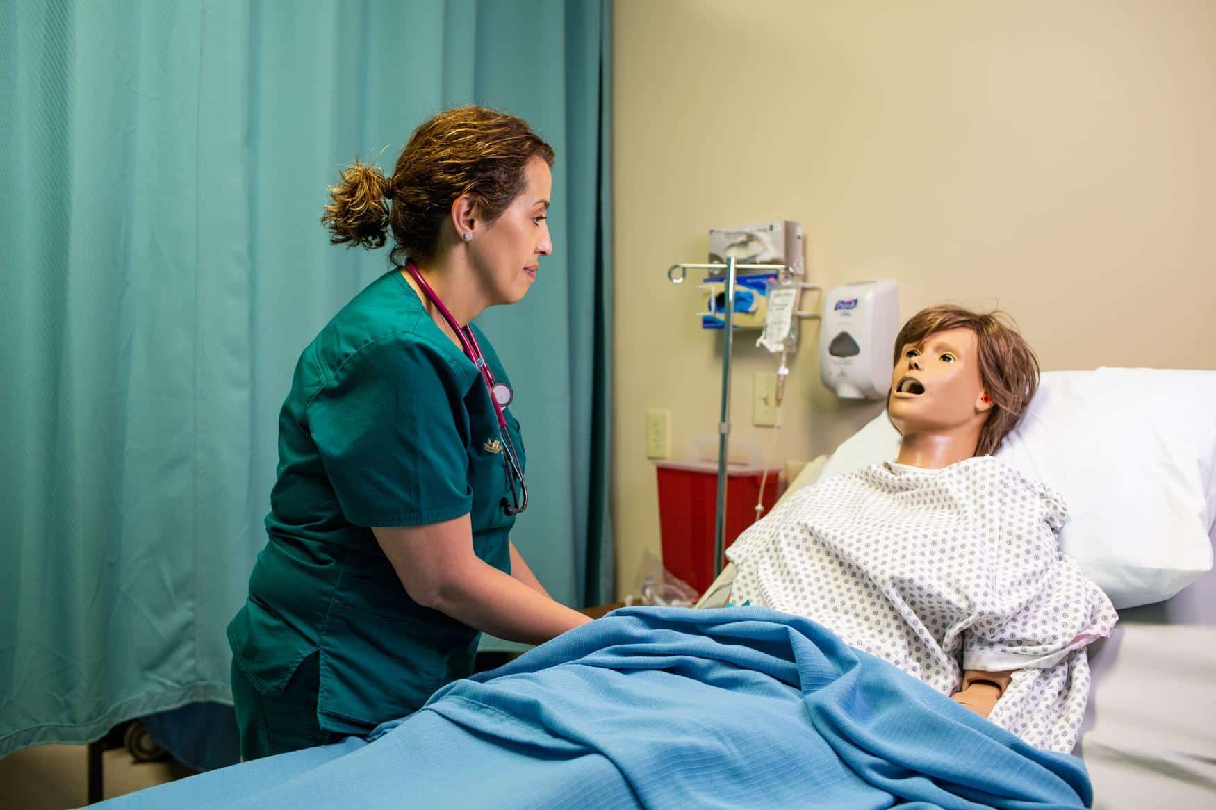 Nurse sitting with a medical dummy