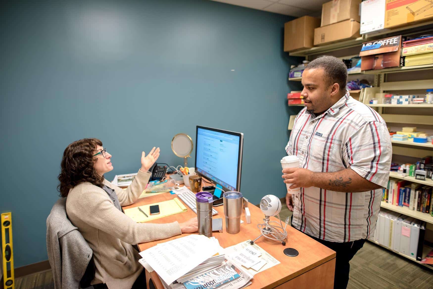 Two people having a discussion in an office