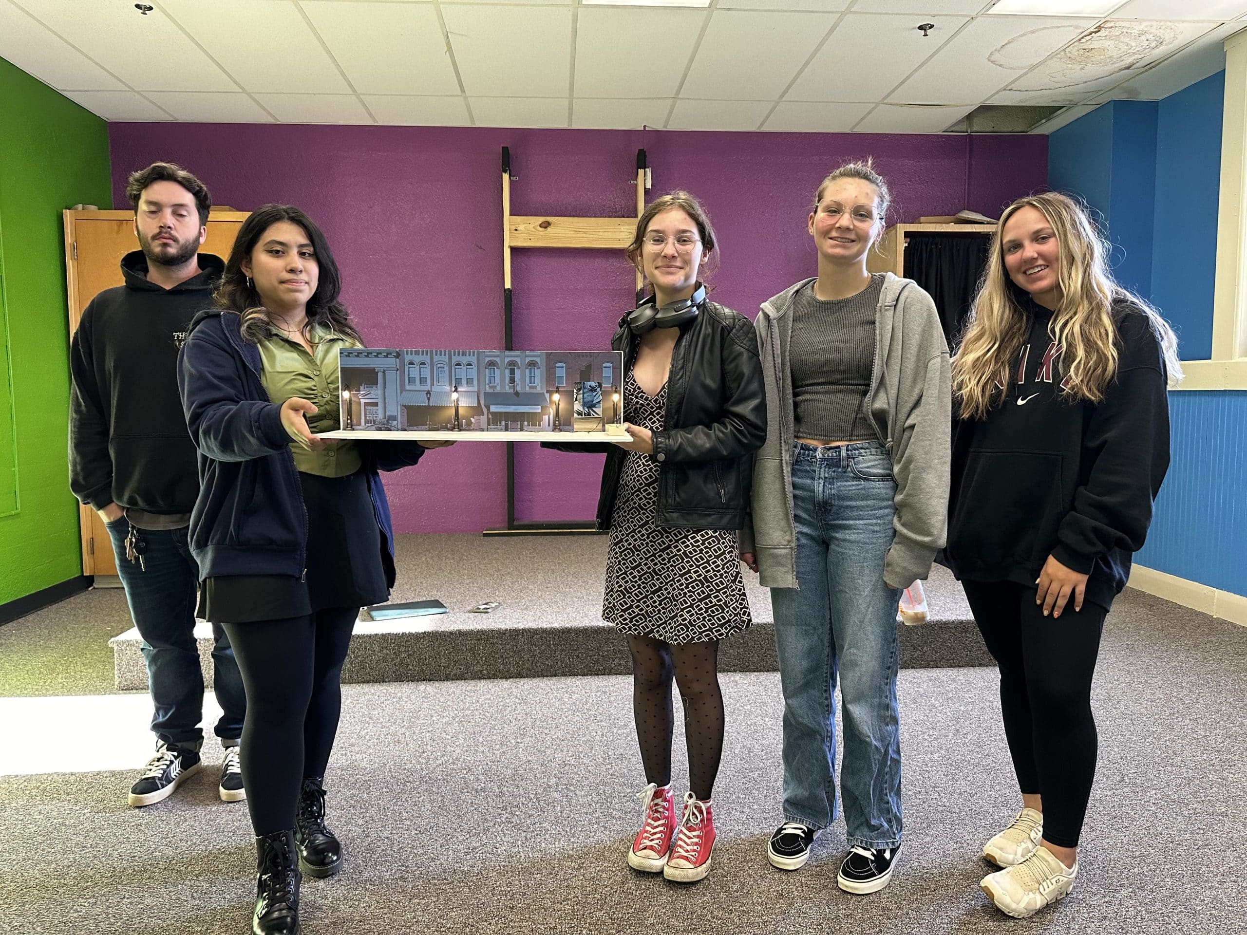 Students posing with an art project