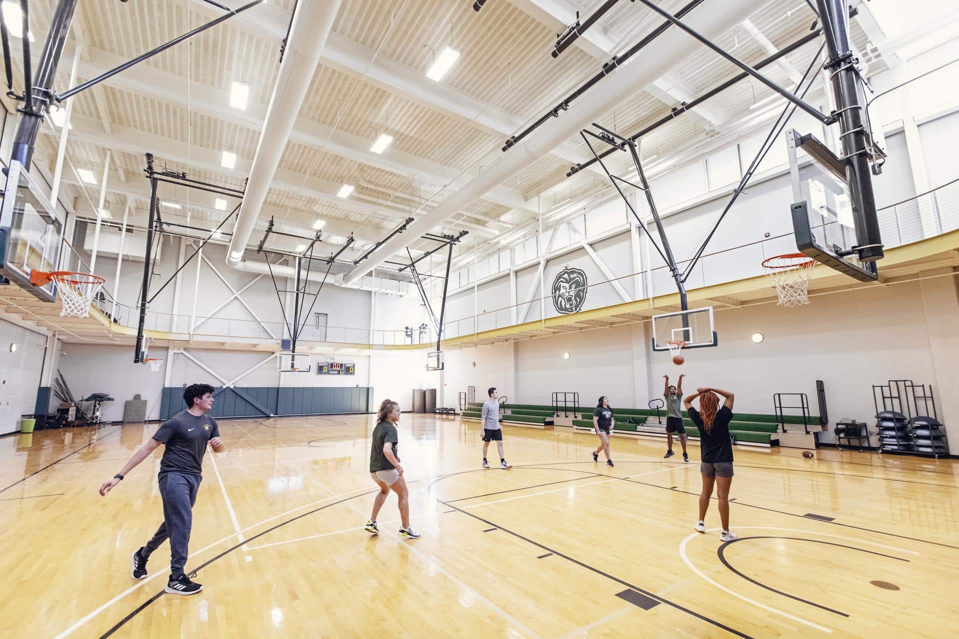 Students playing basketball on an indoor court