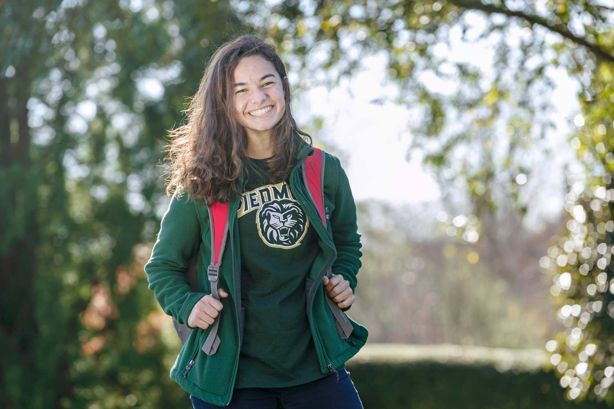 Young woman with a backpack posing and smiling