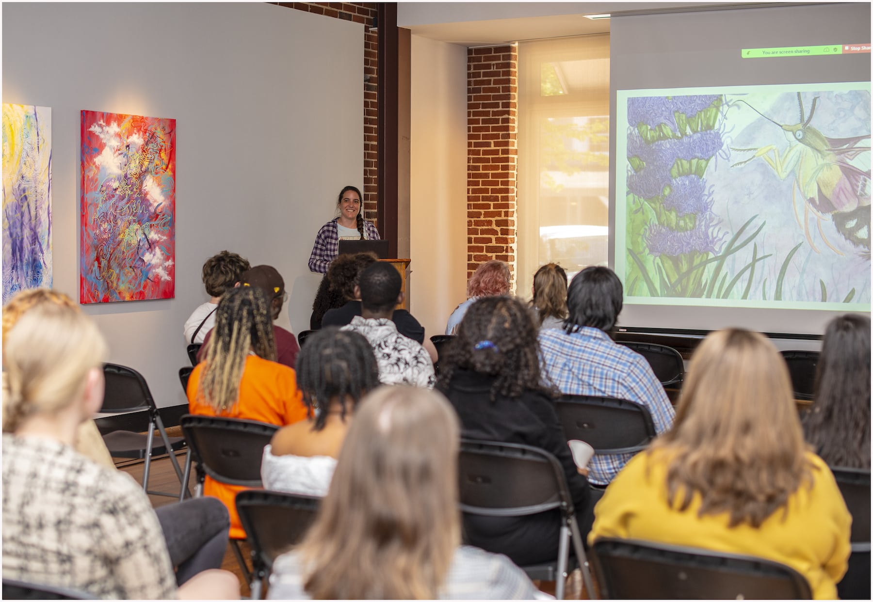 Young woman speaking to a group of students