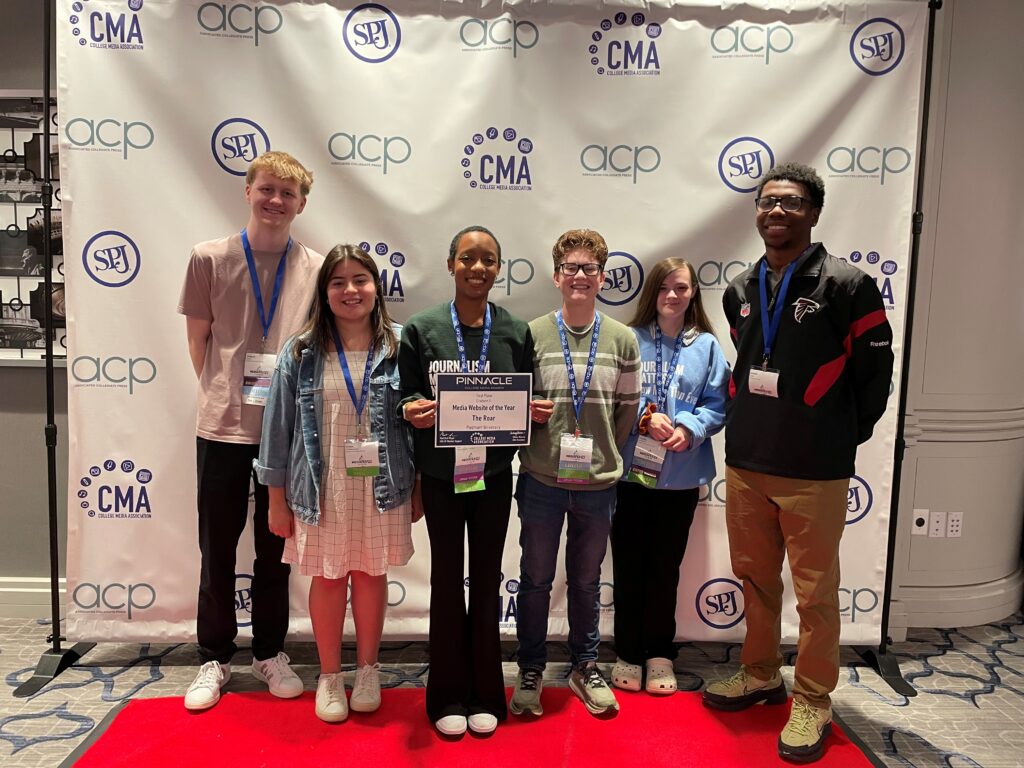 Students pose with Media Website of the Year Award at the Pinnacle Awards.